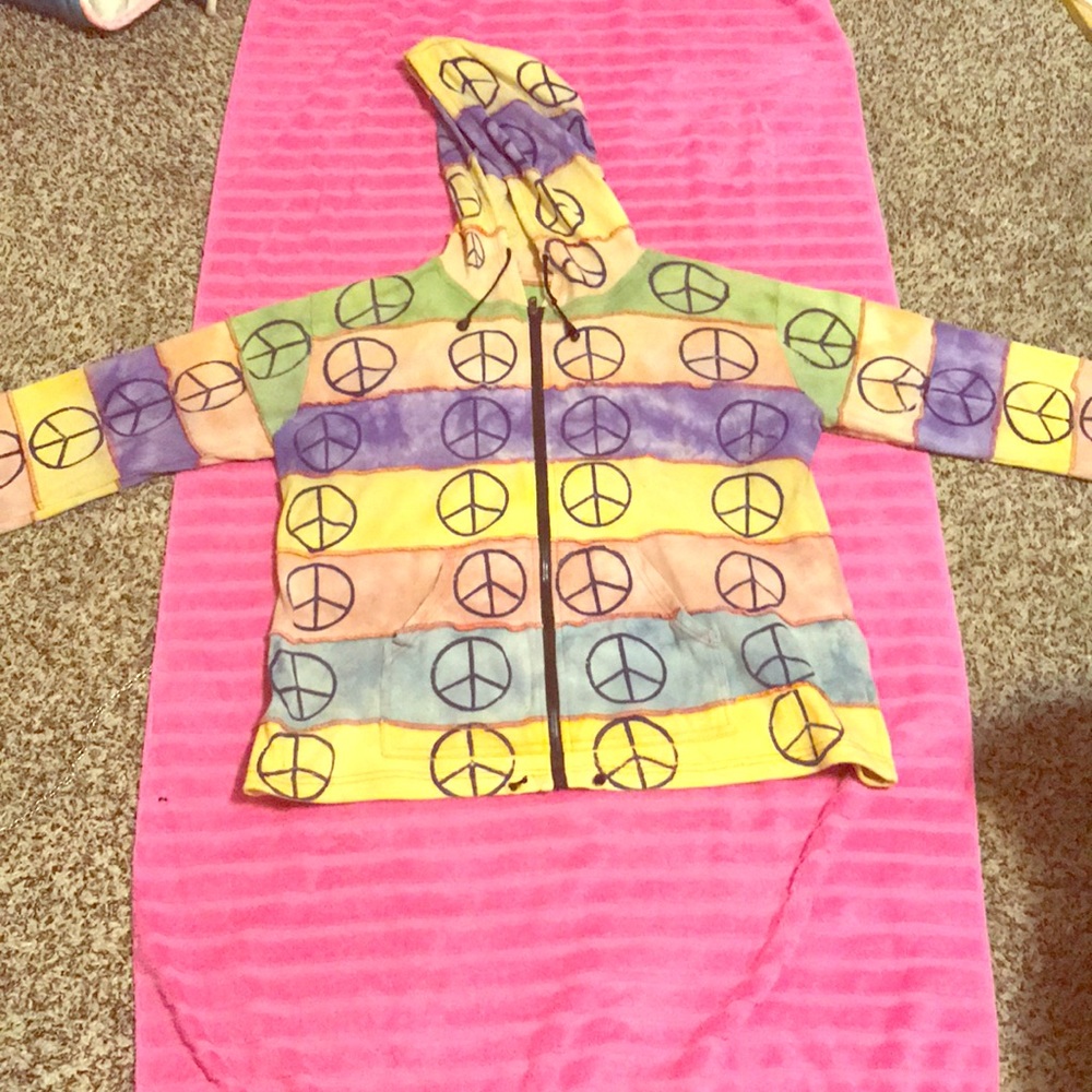 Hippy style jacket with peace signs on it.